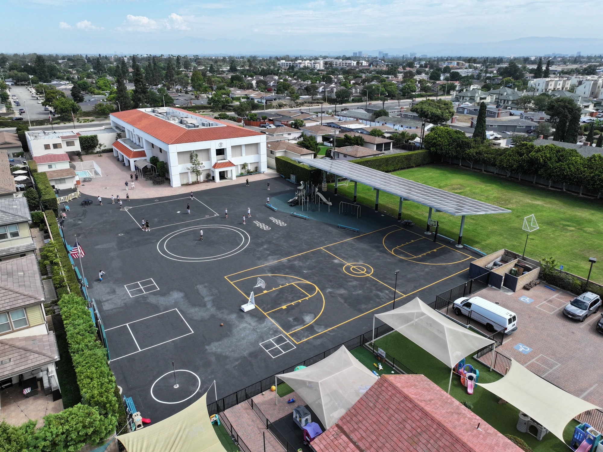 Aerial view of the Page Academy Costa Mesa campus with its field, courts, and playgrounds