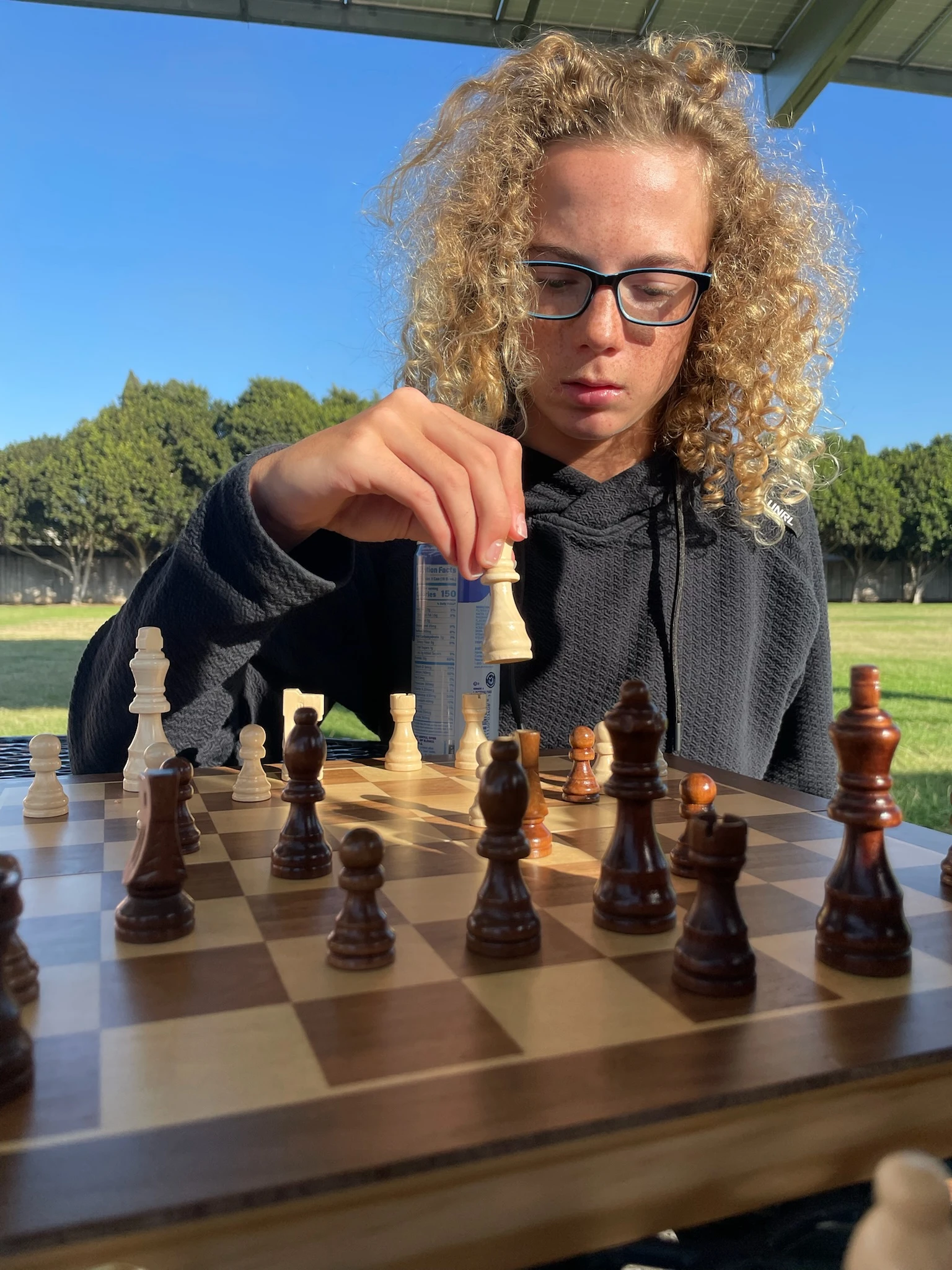 Page Academy middle school student playing chess outdoors