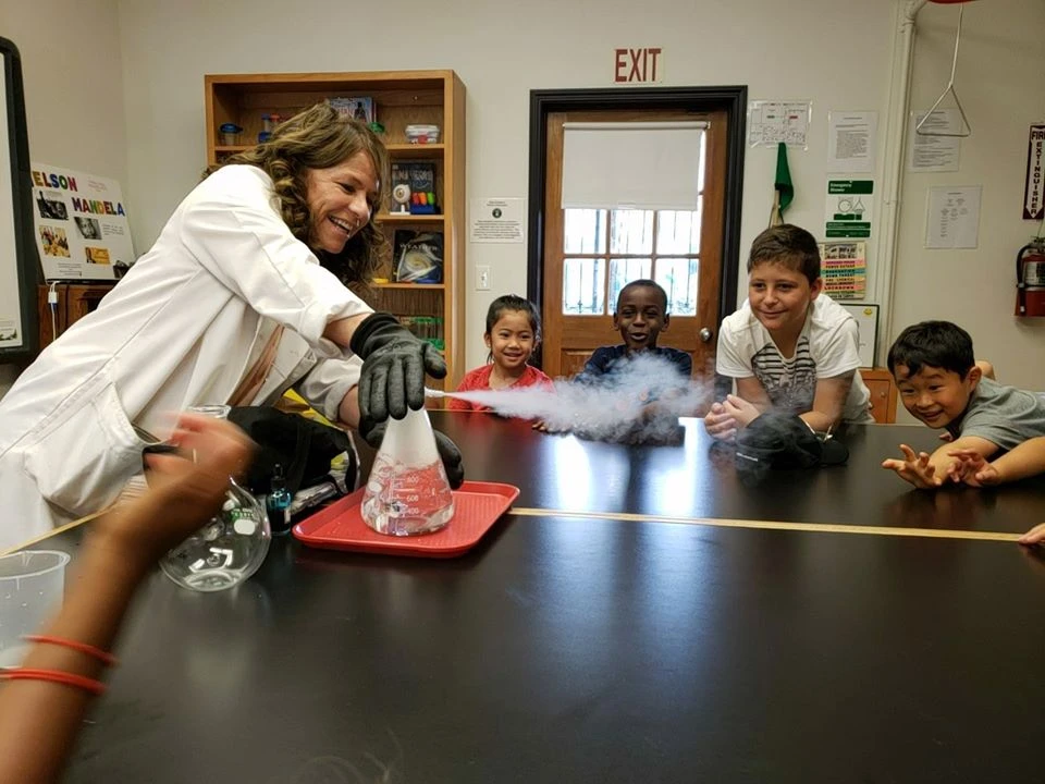 Page Academy teacher leading a science demonstration for a group of students