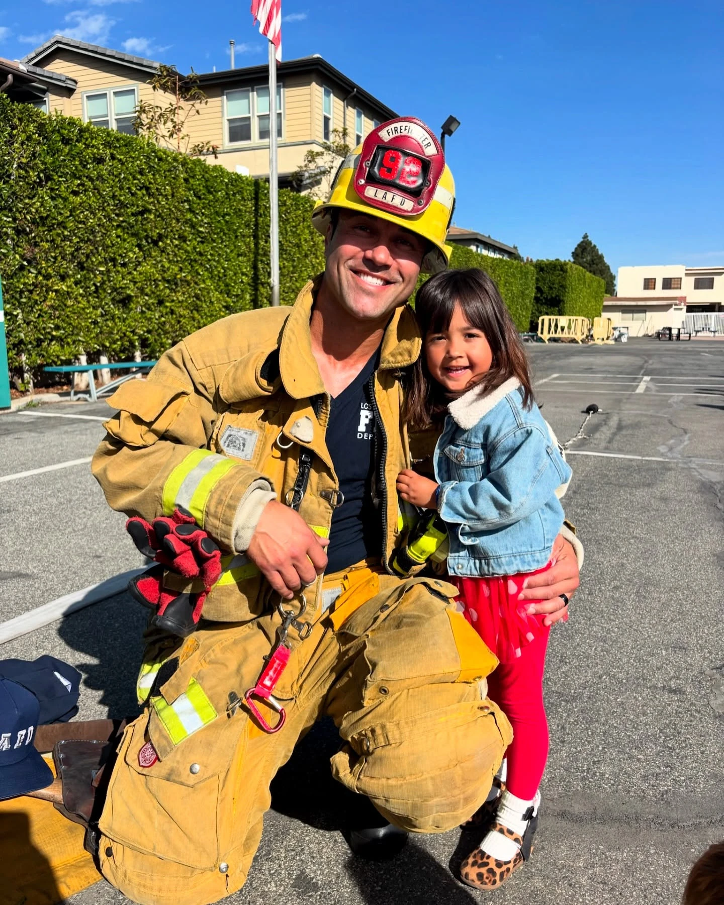 A firefighter visiting with a young Page Academy student on campus