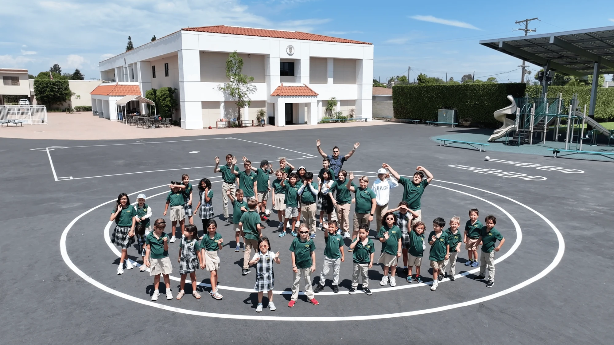 Page Academy students in a circle on the Costa Mesa playground