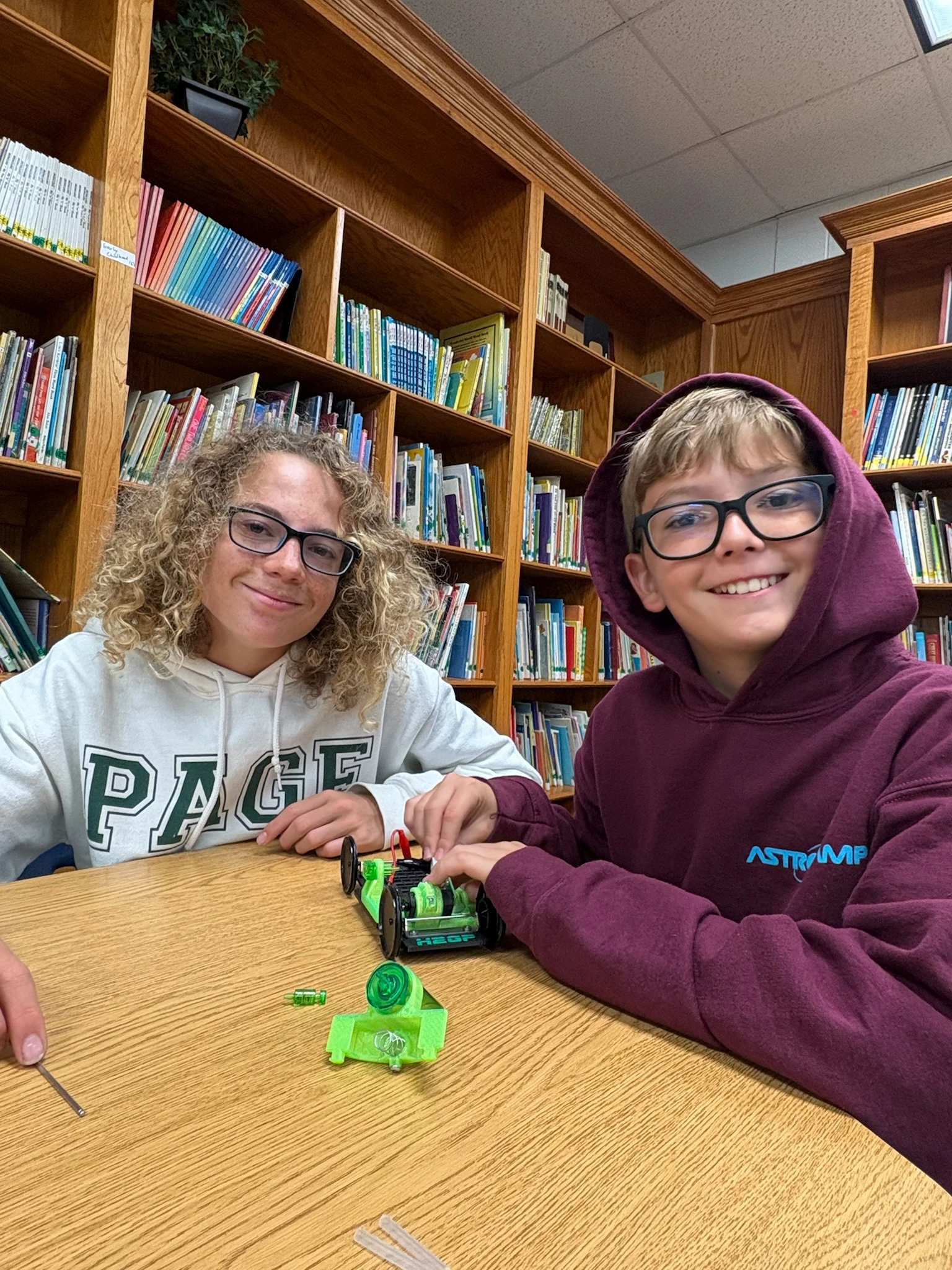Page Academy teacher and student working on a robotics project in the library