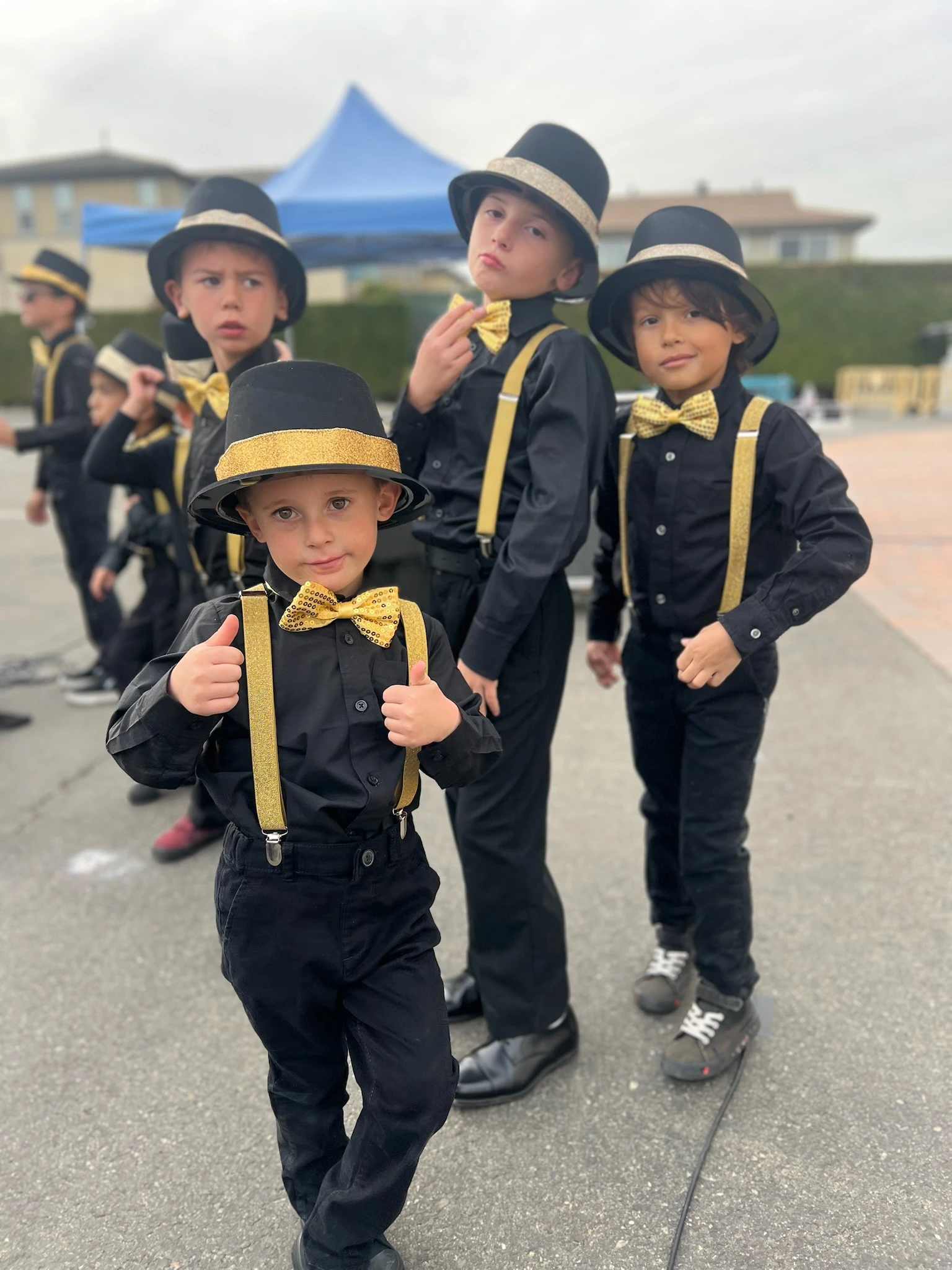 Young Page Academy students dressed in top hats and bow ties for a school performance